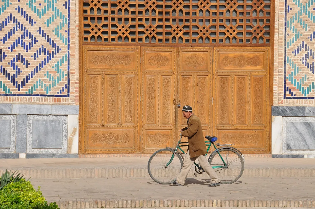A carved wooden door and tilework in Uzbekistan